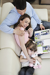 Image showing happy family looking photos at home