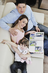 Image showing happy family looking photos at home