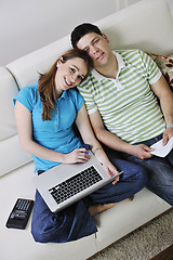 Image showing young couple working on laptop at home