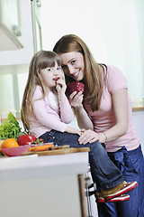 Image showing happy daughter and mom in kitchen