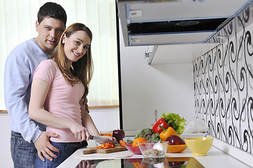 Image showing couple have fun and preparing healthy food in kitchen