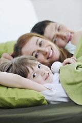 Image showing happy family relaxing in bed