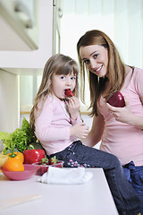 Image showing happy daughter and mom in kitchen