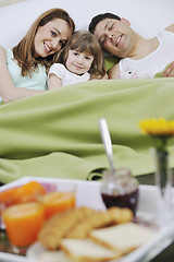 Image showing happy young family eat breakfast in bed