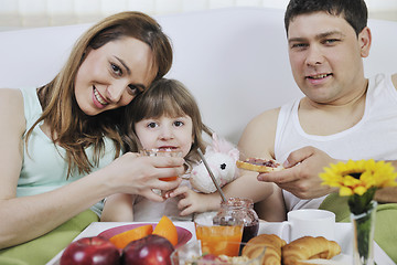 Image showing happy young family eat breakfast in bed