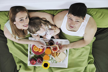 Image showing happy young family eat breakfast in bed