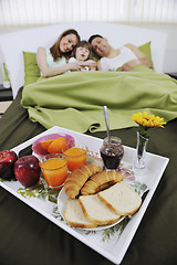 Image showing happy young family eat breakfast in bed