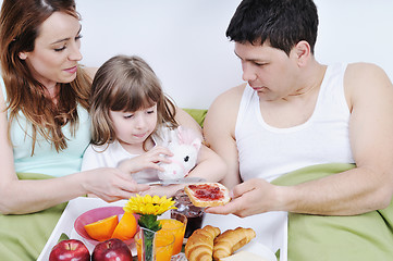 Image showing happy young family eat breakfast in bed