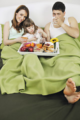 Image showing happy young family eat breakfast in bed