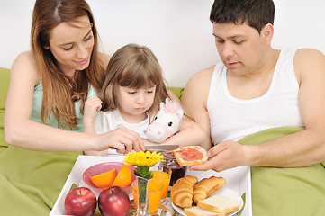 Image showing happy young family eat breakfast in bed