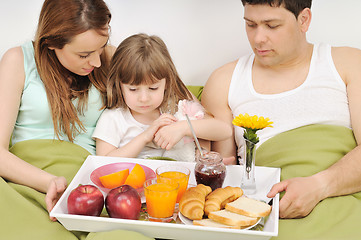 Image showing happy young family eat breakfast in bed