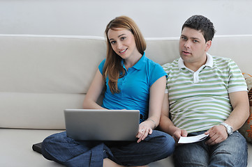 Image showing young couple working on laptop at home