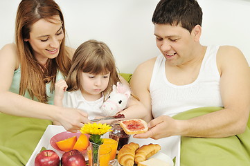 Image showing happy young family eat breakfast in bed