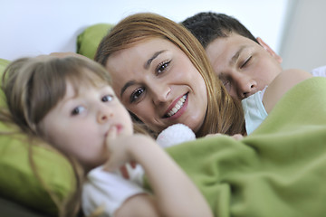 Image showing happy family relaxing in bed