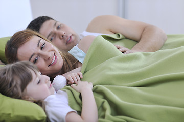 Image showing happy family relaxing in bed