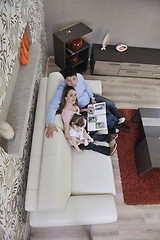 Image showing happy family looking photos at home