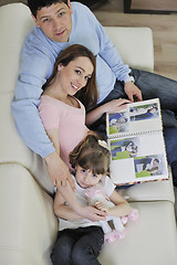 Image showing happy family looking photos at home