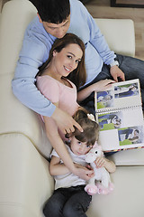 Image showing happy family looking photos at home