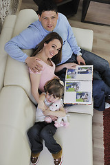 Image showing happy family looking photos at home