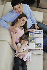 Image showing happy family looking photos at home