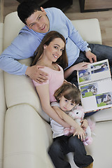 Image showing happy family looking photos at home