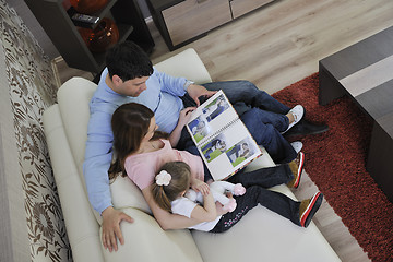 Image showing happy family looking photos at home