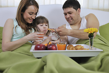 Image showing happy young family eat breakfast in bed