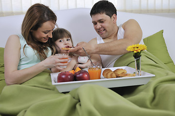 Image showing happy young family eat breakfast in bed