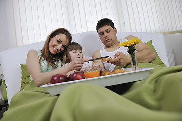 Image showing happy young family eat breakfast in bed