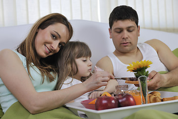 Image showing happy young family eat breakfast in bed