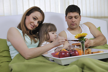 Image showing happy young family eat breakfast in bed