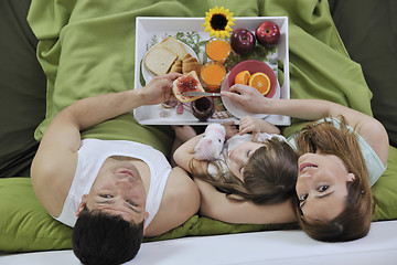 Image showing happy young family eat breakfast in bed