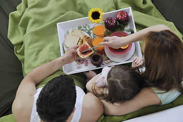 Image showing happy young family eat breakfast in bed