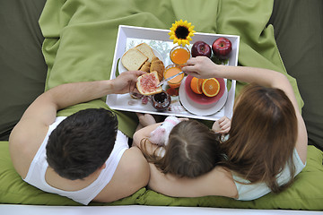 Image showing happy young family eat breakfast in bed