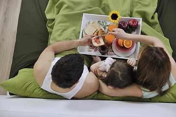 Image showing happy young family eat breakfast in bed