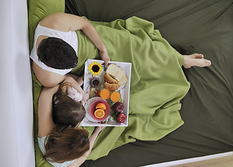 Image showing happy young family eat breakfast in bed