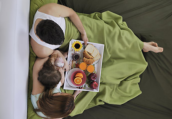 Image showing happy young family eat breakfast in bed