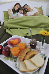 Image showing happy young family eat breakfast in bed