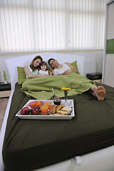 Image showing happy young family eat breakfast in bed