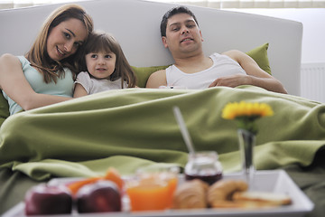 Image showing happy young family eat breakfast in bed