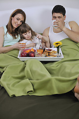 Image showing happy young family eat breakfast in bed