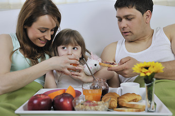 Image showing happy young family eat breakfast in bed