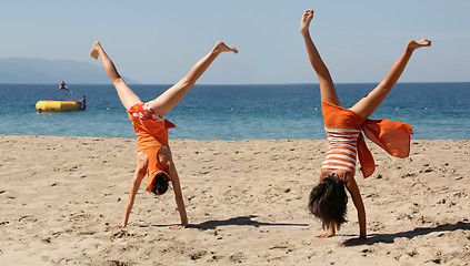 Image showing Two girls doing cartwheel