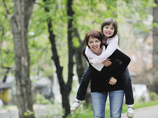 Image showing happy girl and mom outdoor