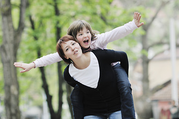 Image showing happy girl and mom outdoor