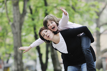 Image showing happy girl and mom outdoor