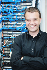 Image showing young it engeneer in datacenter server room