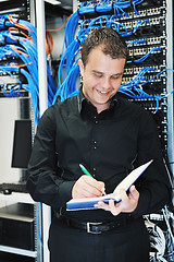 Image showing young it engeneer in datacenter server room