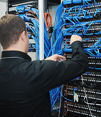 Image showing young it engeneer in datacenter server room