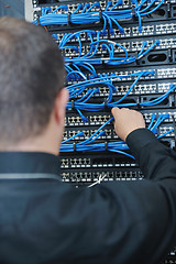 Image showing young it engeneer in datacenter server room